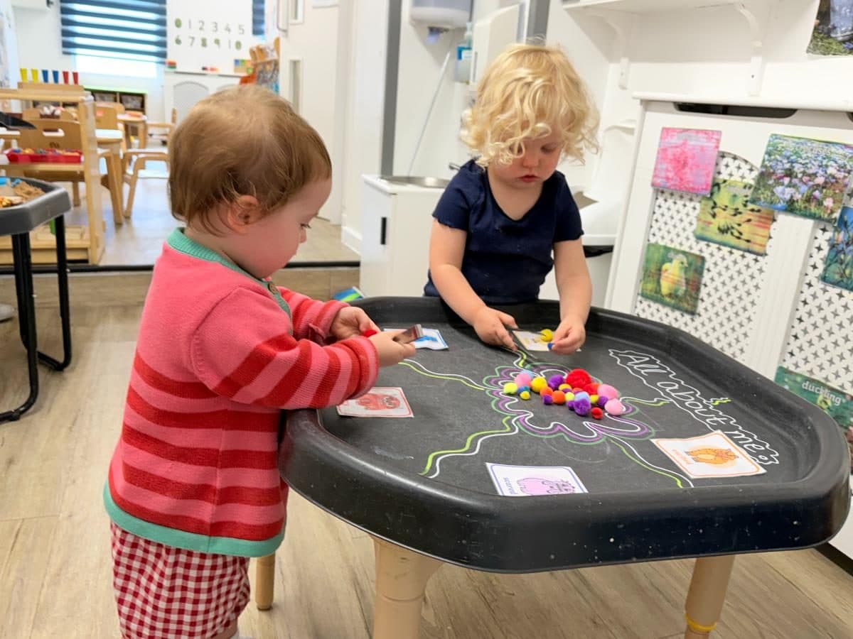 Unique child montessori children engaged in colorful sensory play activity