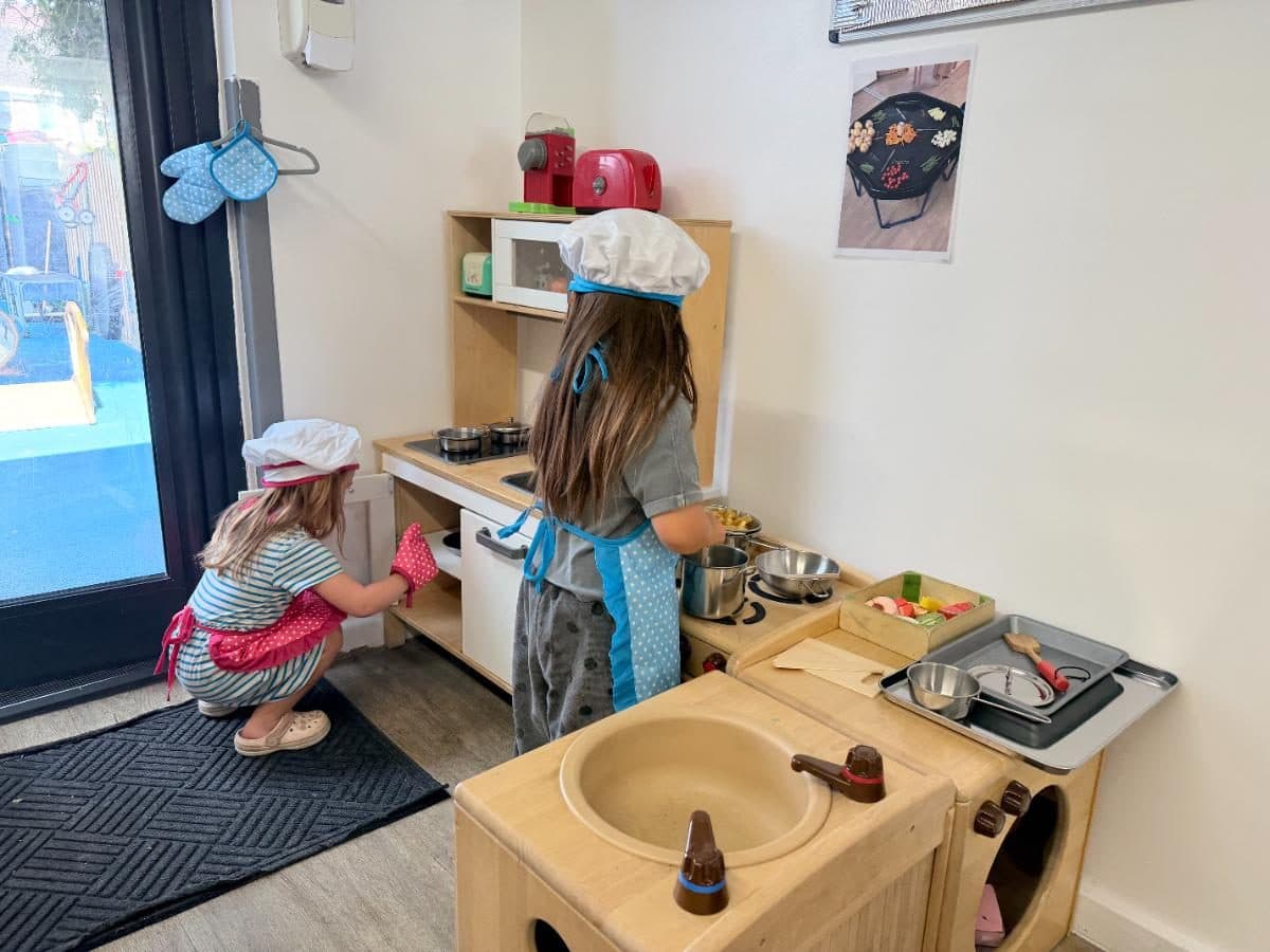 Unique child montessori children playing kitchen roleplay