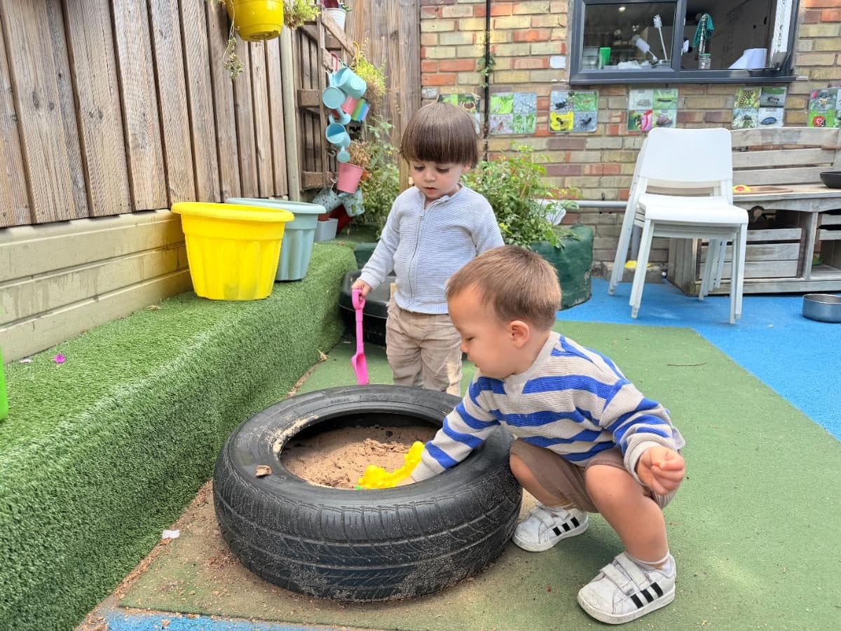 Unique child montessori children playing sandbox tire