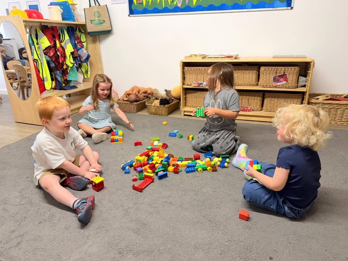 Unique child montessori children playing with building blocks