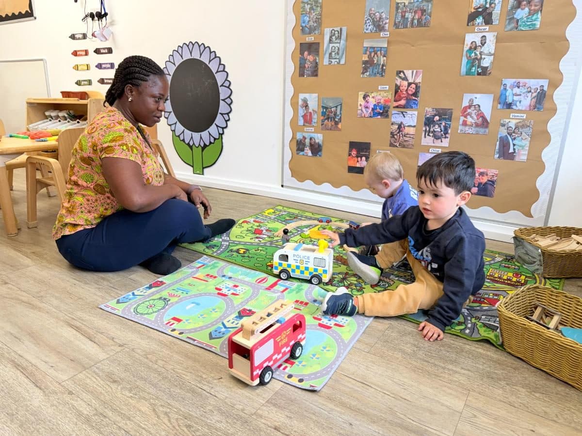 Unique child montessori practitioner and children playing together