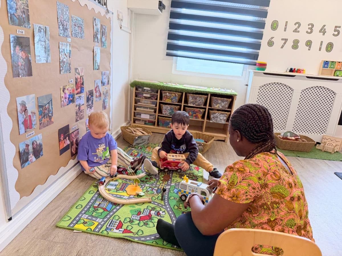 Unique child montessori practitioners and children playing together indoors