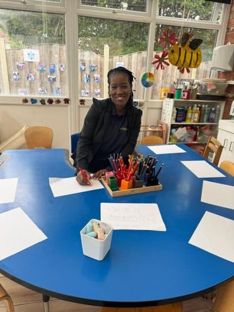 Practitioner at a blue table in northolts unique child montessori classroom