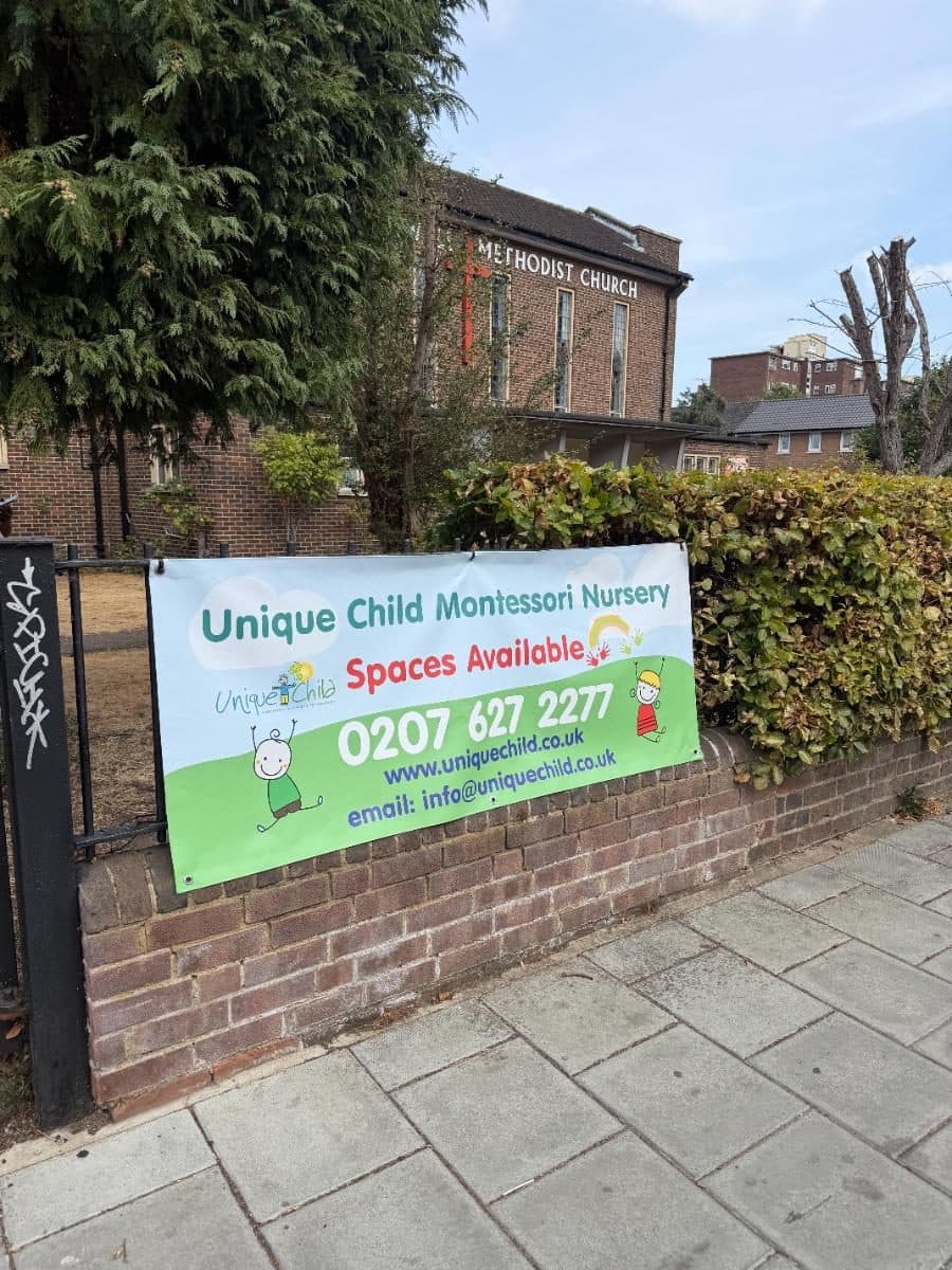 Unique child montessori nursery sign on brick wall